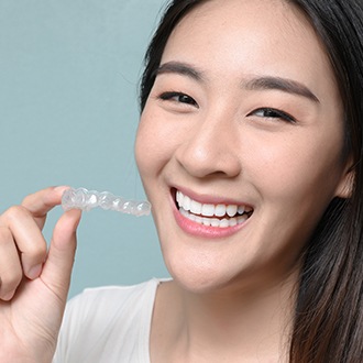 Woman holding a clear aligner
