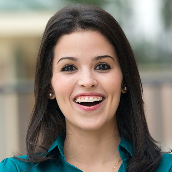 Woman with clear and ceramic braces smiling