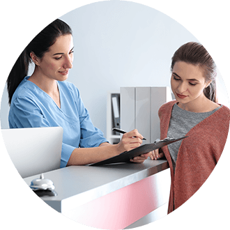 Patient reviewing dental insurance forms with team member