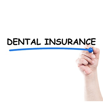 Patient underlining dental insurance in blue marker