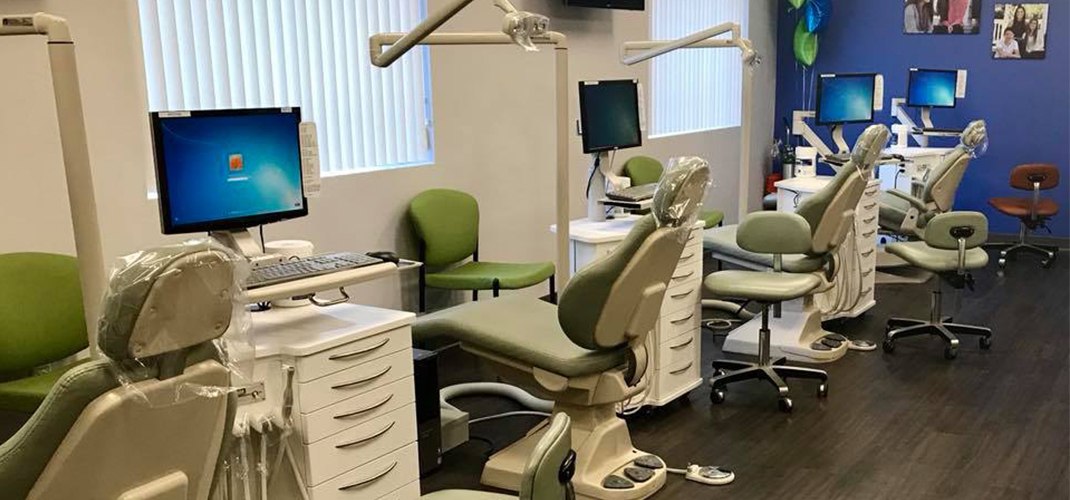 Row of green orthodontic treatment chairs