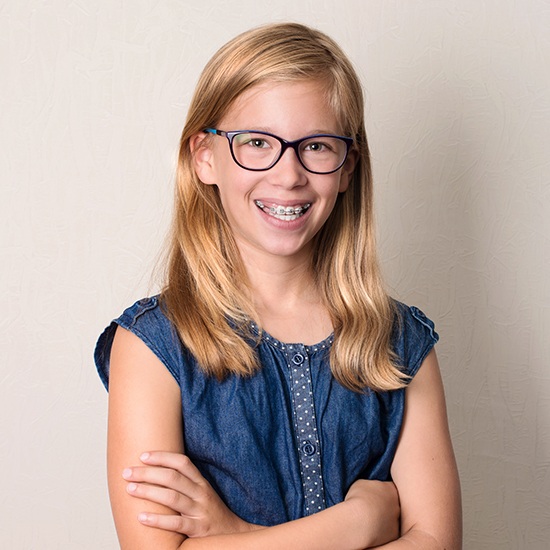 Young girl with pediatric orthodontics smiling