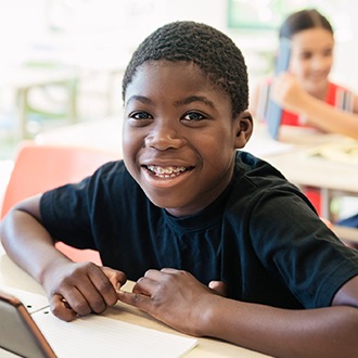 Young boy with pediatric orthodontics smiling