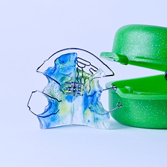 Pediatric orthodontic appliance next to carrying case