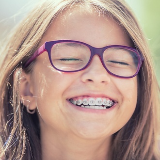 Laughing girl with pediatric orthodontics