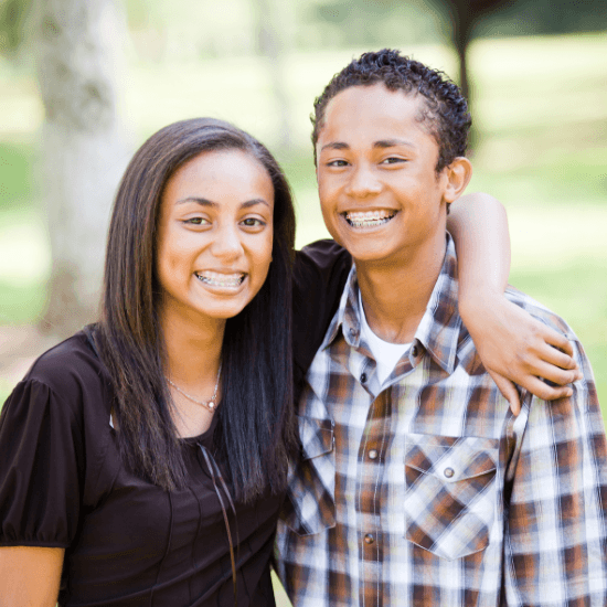 Teen boy and girl with orthodontics