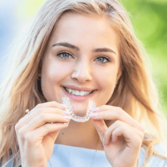 Teen girl placing Invisalign clear aligner tray