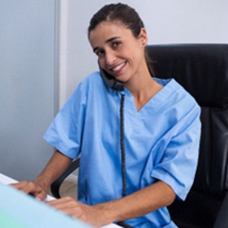 Orthodontic assistant smiling while answering phone