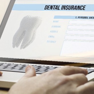 Closeup of patient filling out dental insurance information online