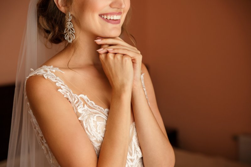 Closeup of bride smiling in wedding gown