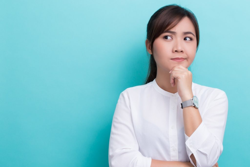 Closeup of woman wondering about Invisalign