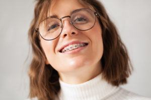 an adult patient with braces smiling